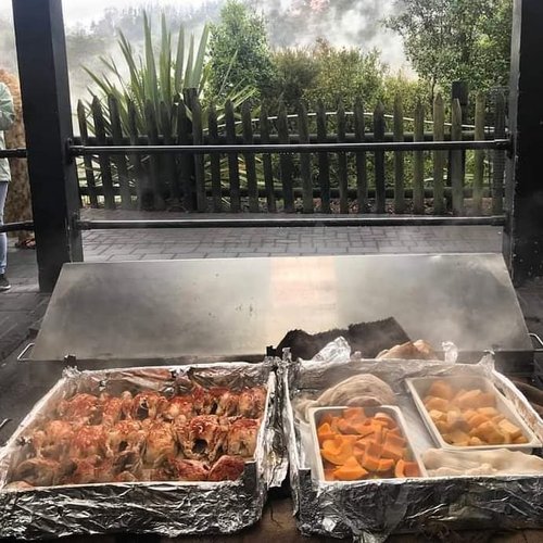 Traditional Maori hangi meal steaming in trays as it is served in Rotorua